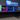 Finished Hyper Cyber gaming PCs with visible interiors displayed beneath the Hyper Cyber wall logo in Tampa.